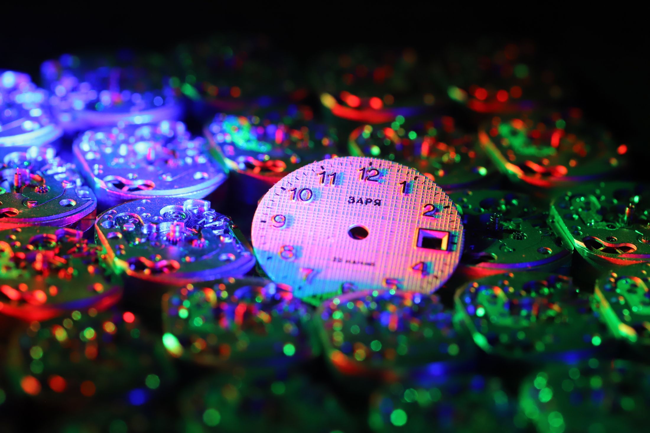 Colorful watch dial components showing luminous material theme